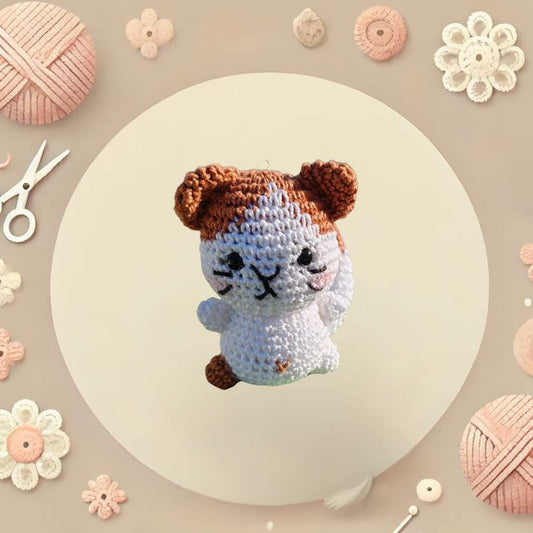 Crochet cat-shaped amigurumi with a compact body, pointed ears, and a sweet expression.